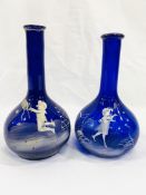 Two blue cameo glass bottles