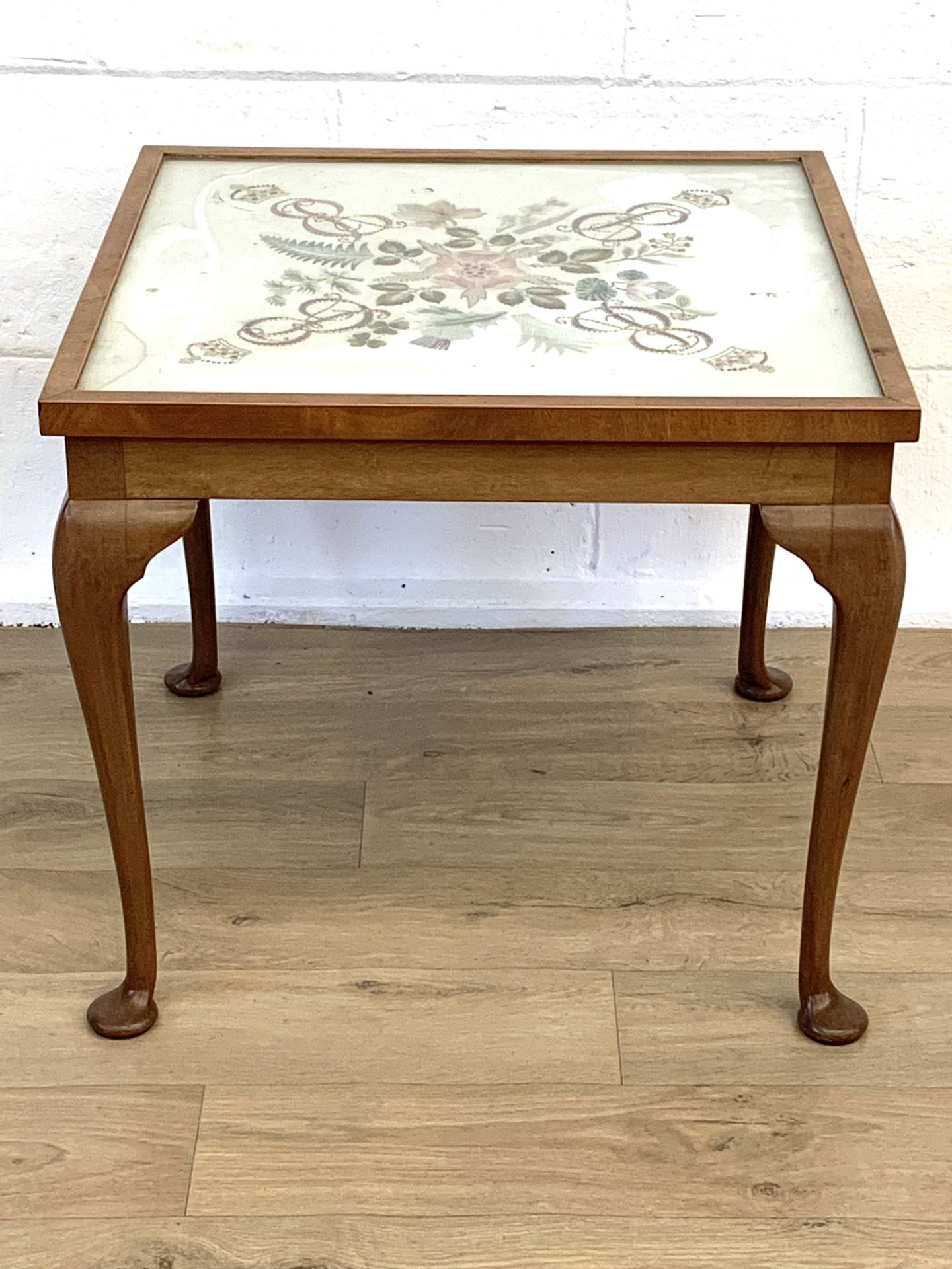 Mahogany framed side table with glazed embroidered panel to top