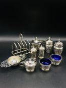 A five piece cruet set by Mappin & Webb, 1926, and other cruets