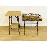 A bamboo side table and a folding metal table with wicker top