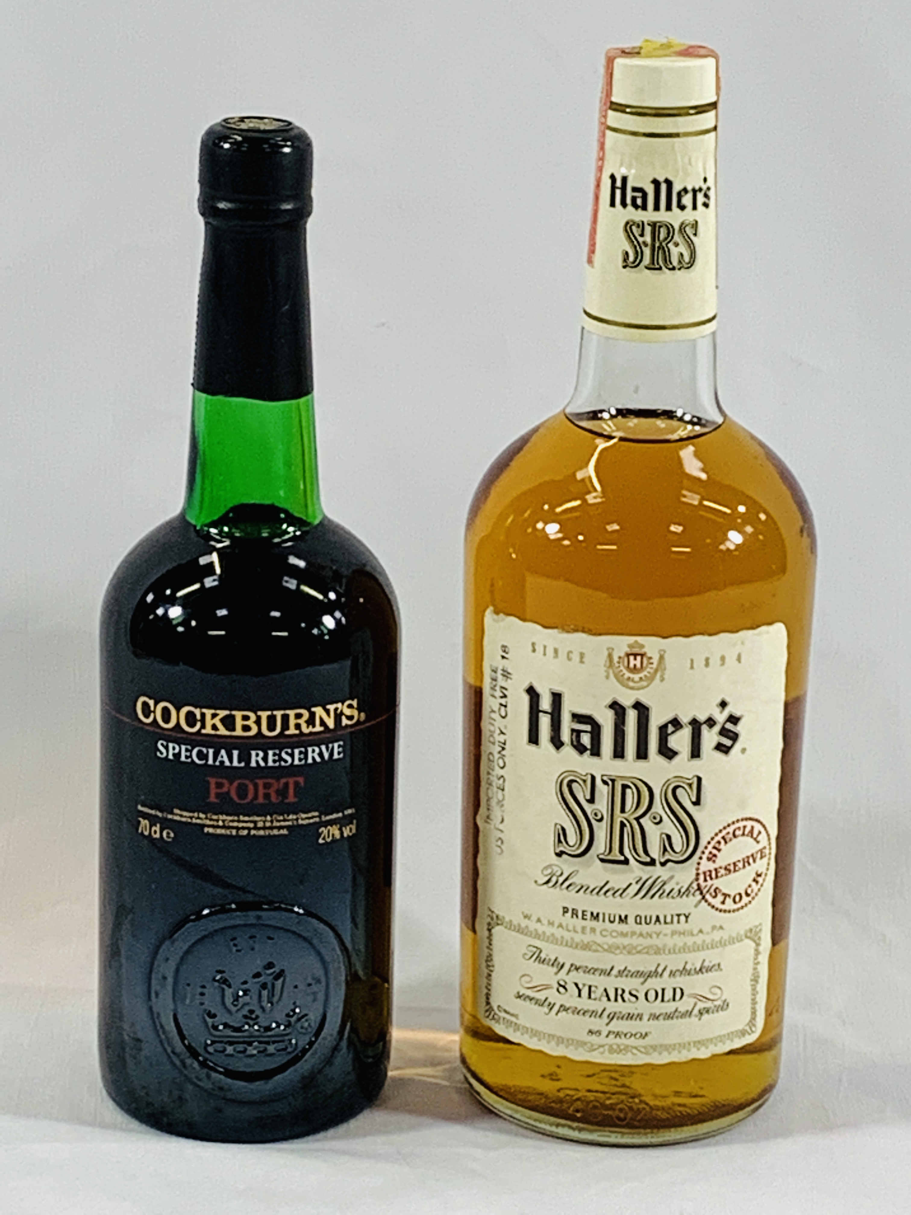 A bottle of Haller's whisky together with a bottle of Cockburn's port