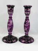 A pair of amethyst coloured glass candlesticks