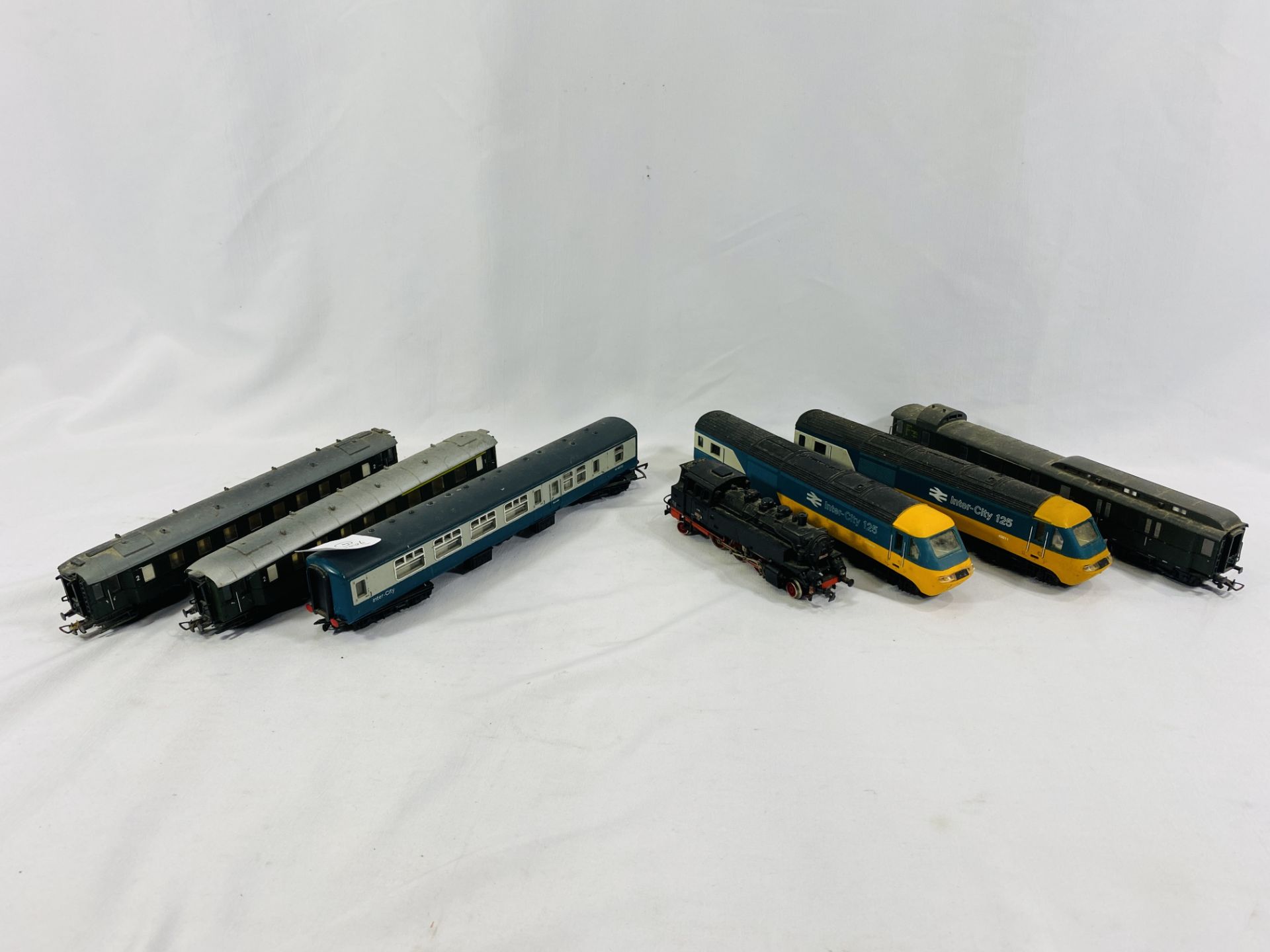 Thee 00 gauge locomotives and four 00 gauge carriages