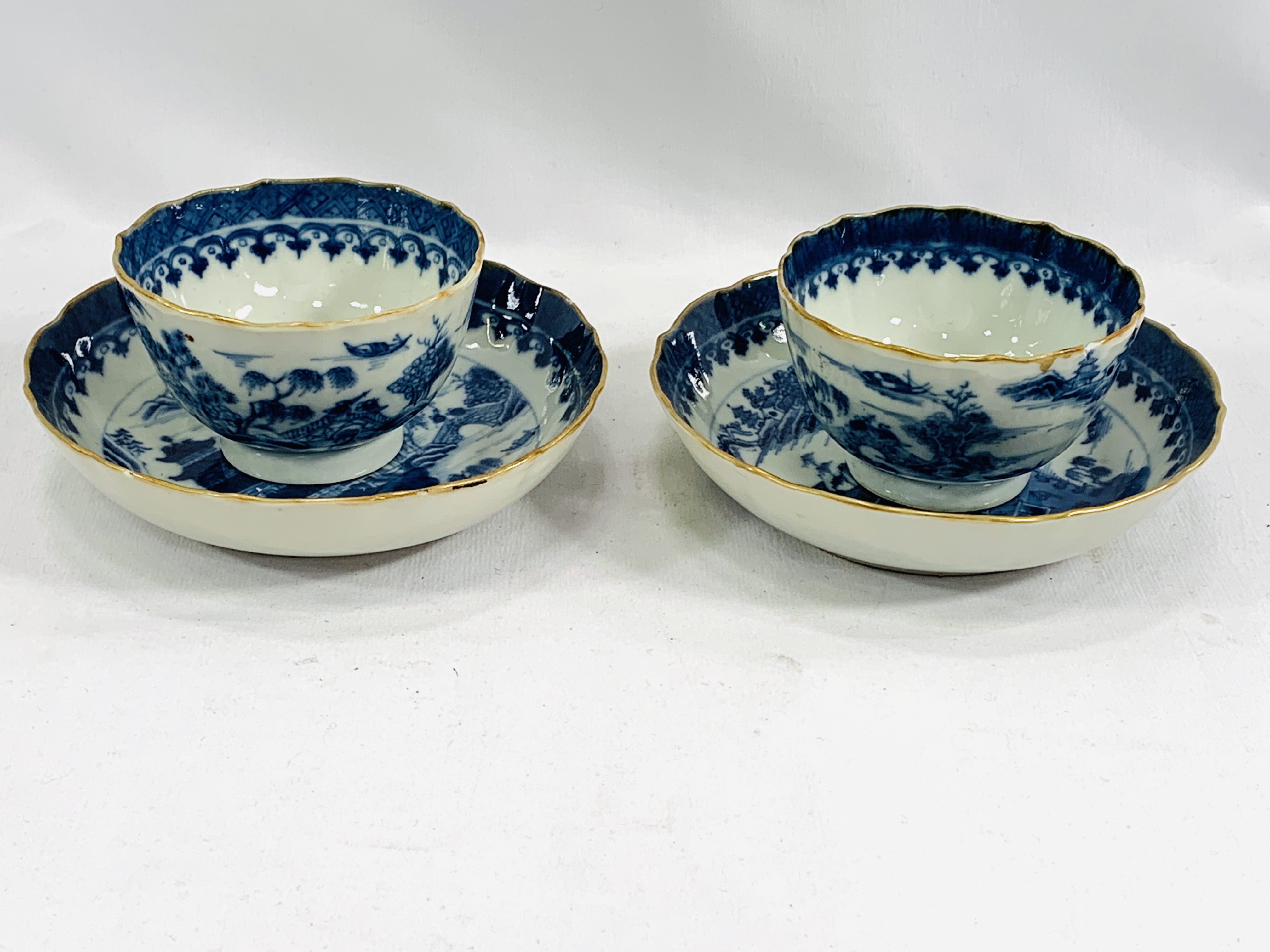 Two blue and white tea bowls and saucers