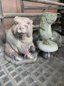 A cast concrete pig and dog