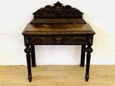 Carved oak writing table
