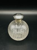 Early 20th century cut glass toilet water bottle with silver top