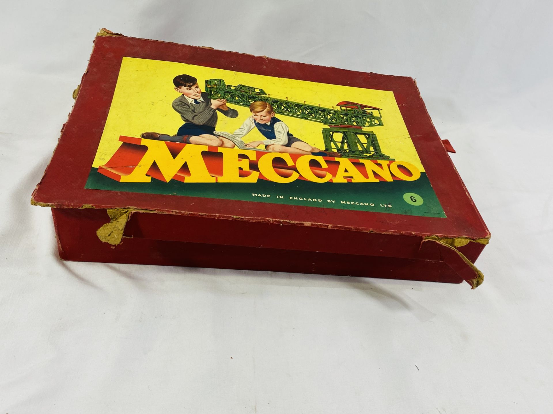A box containing a quantity of Meccano and instruction books