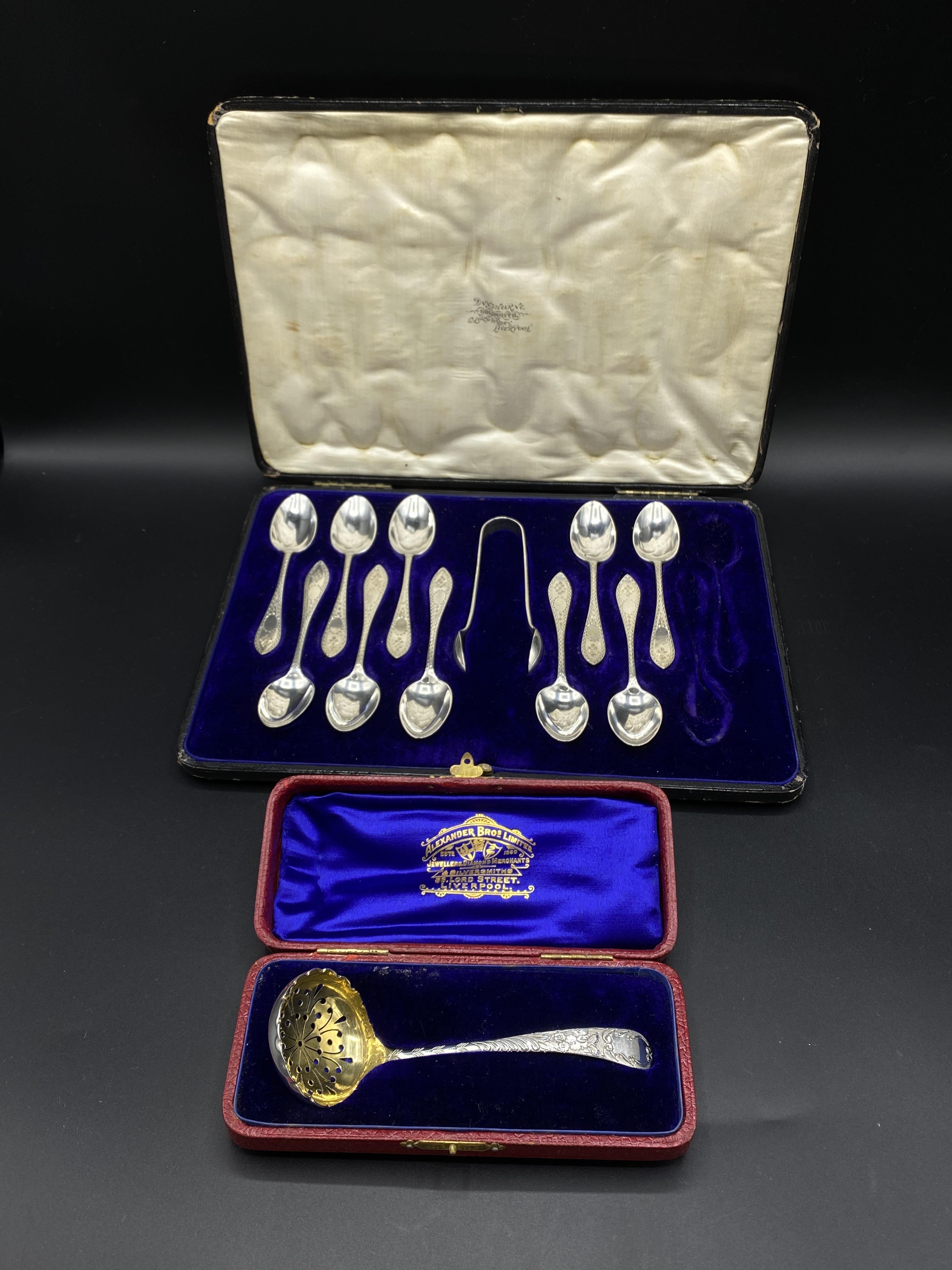 Set of ten silver teaspoons and a pair of sugar tongs, and a silver sugar sifter spoon