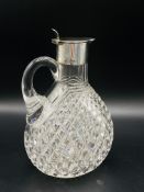 Cut glass claret jug with silver lidded spout