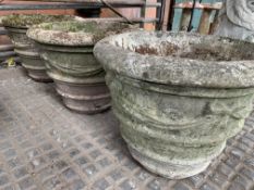 Three cast concrete planters