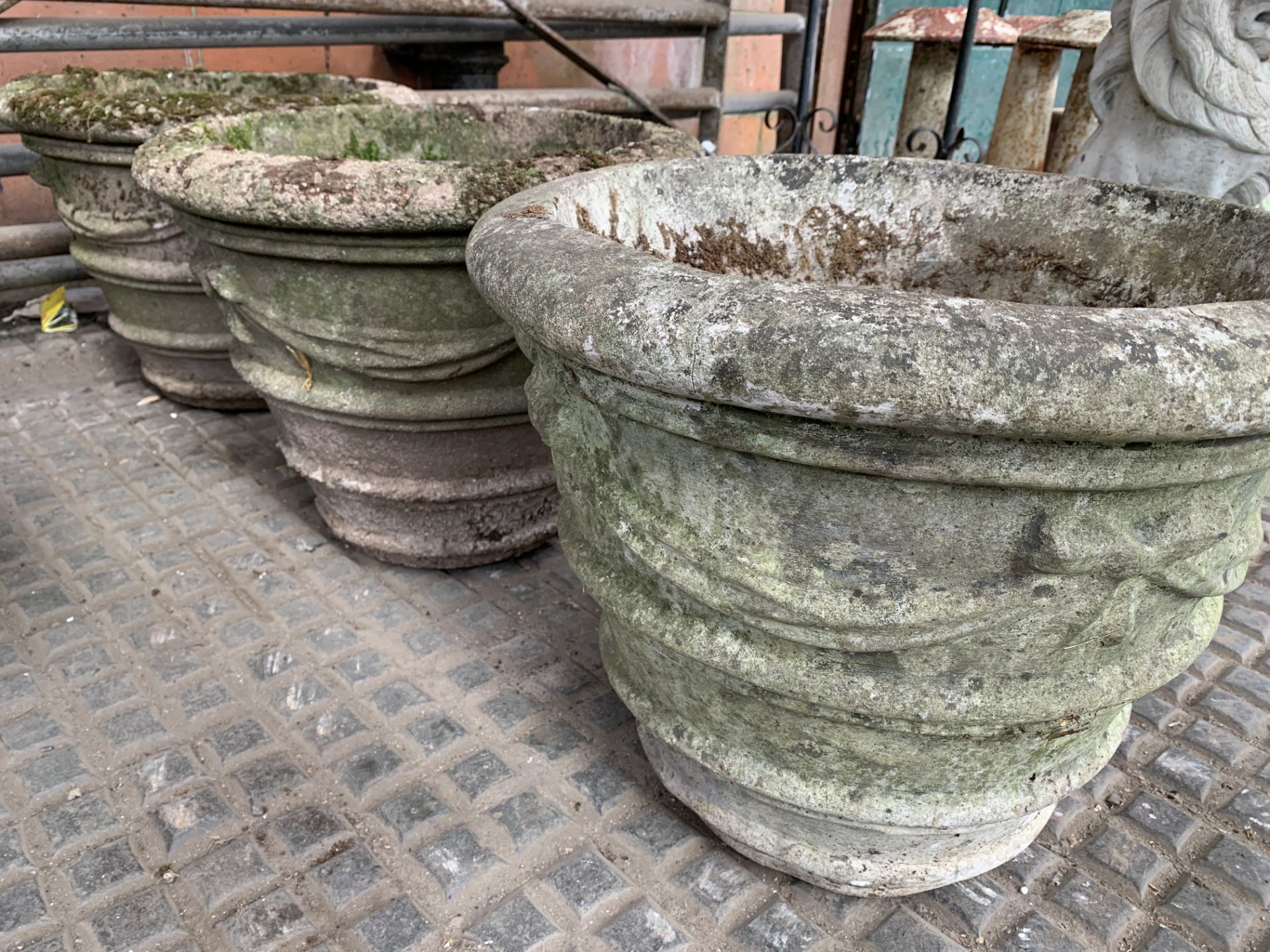 Three cast concrete planters