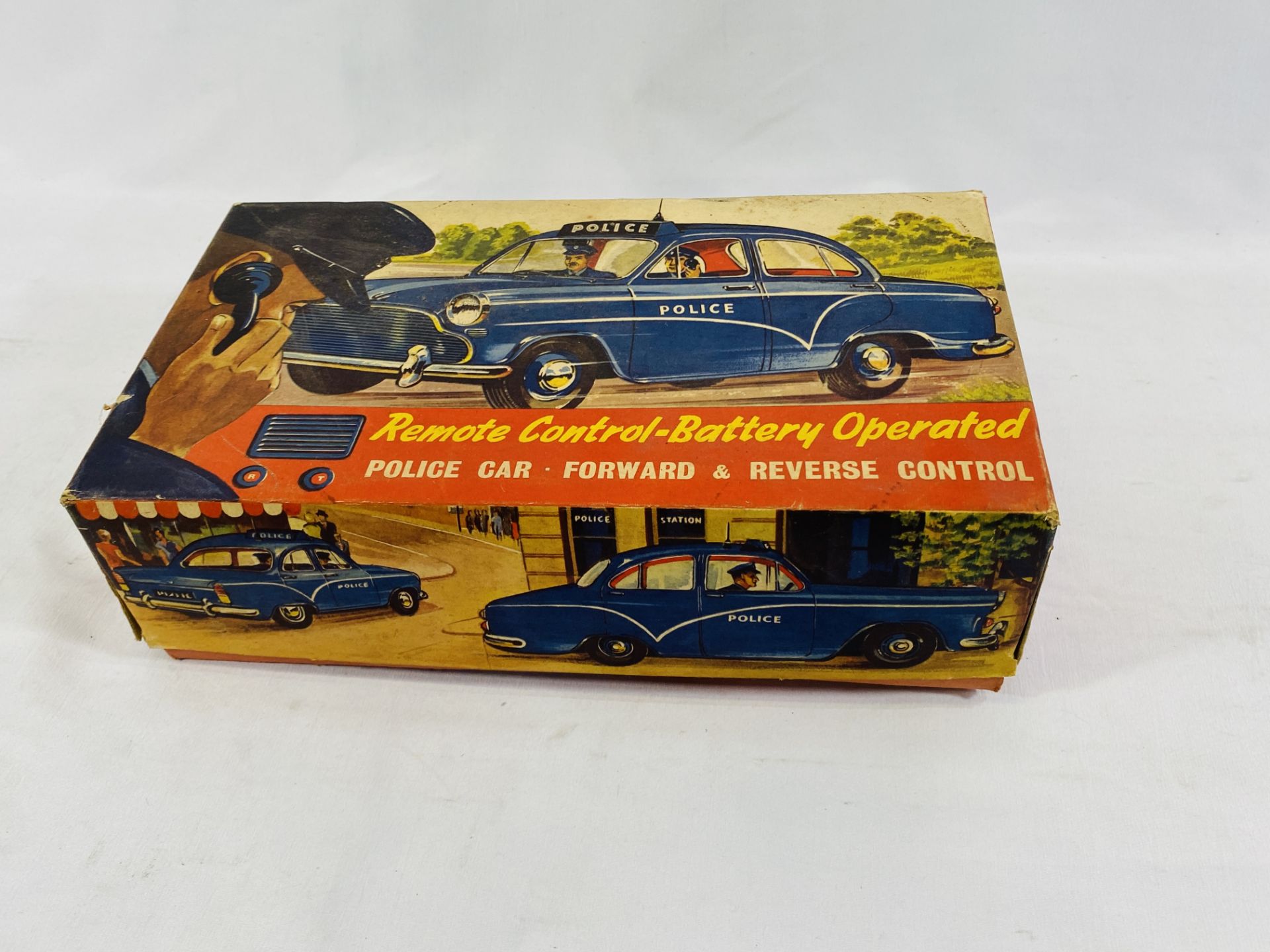 A boxed tinplate battery operated police car