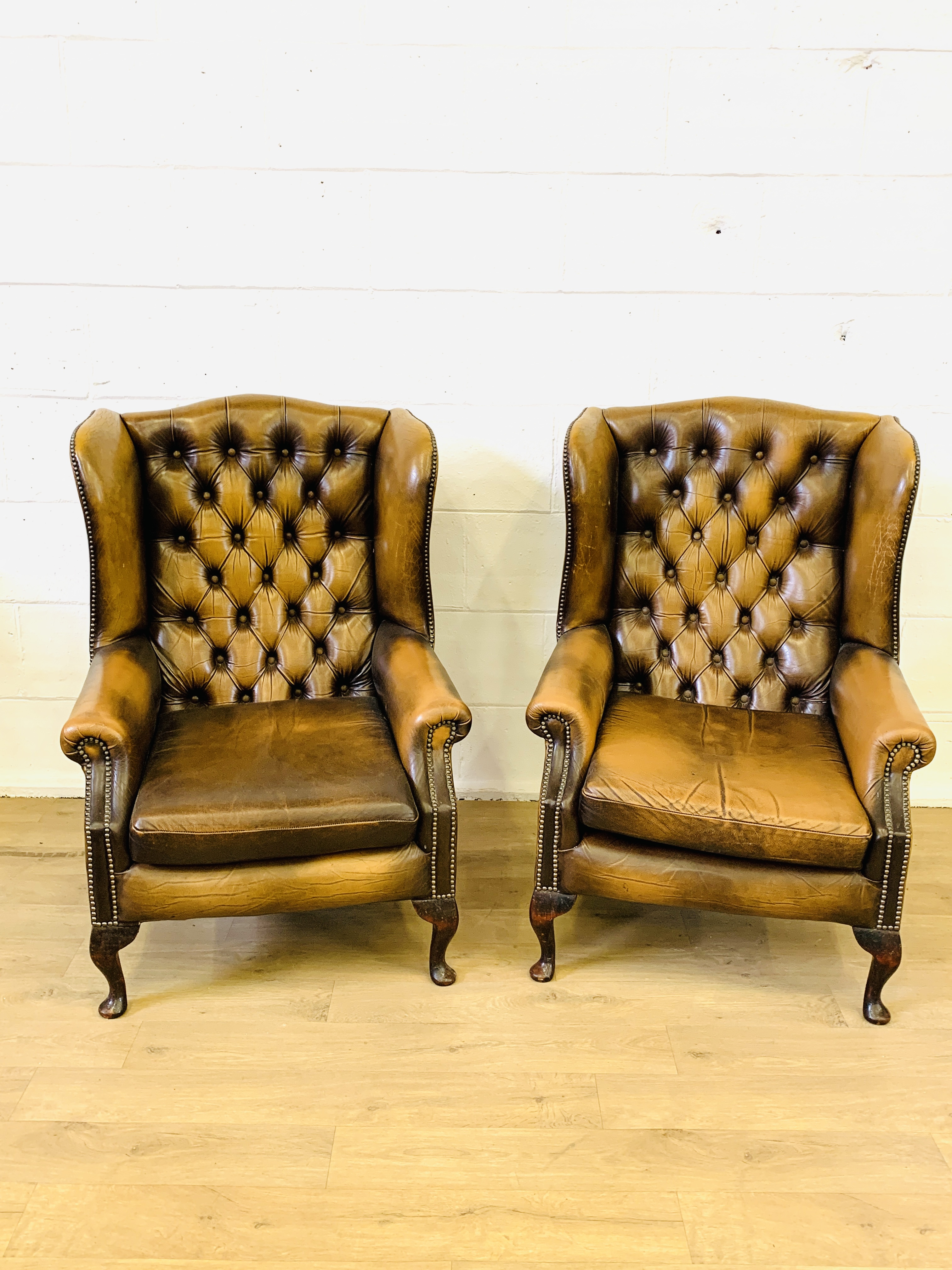 Two leather style armchairs