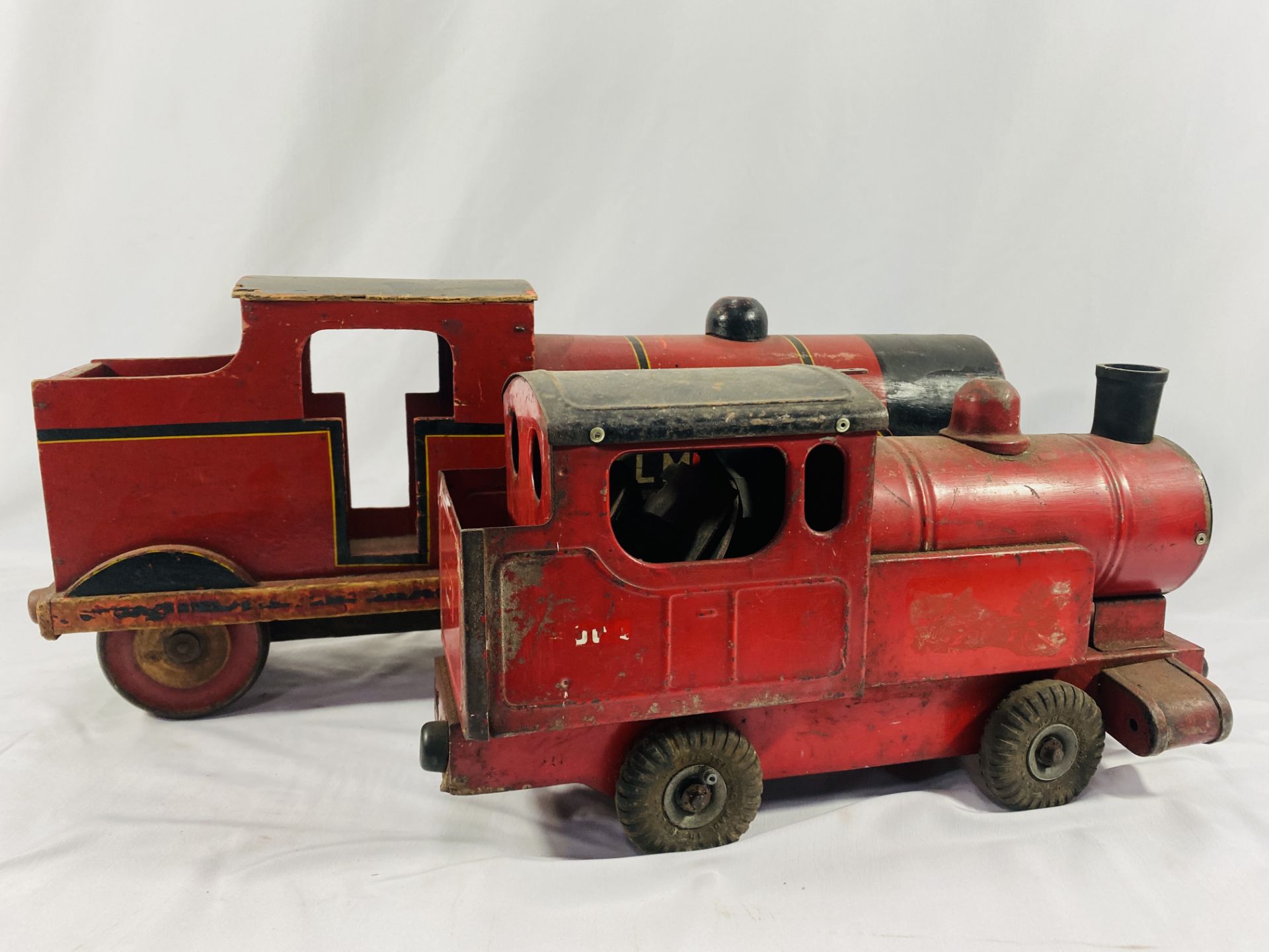 A wooden toy locomotive, a metal toy locomotive