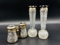 A pair of Victorian cut glass spill vases with silver rims and a pair of silver cased opera glasses