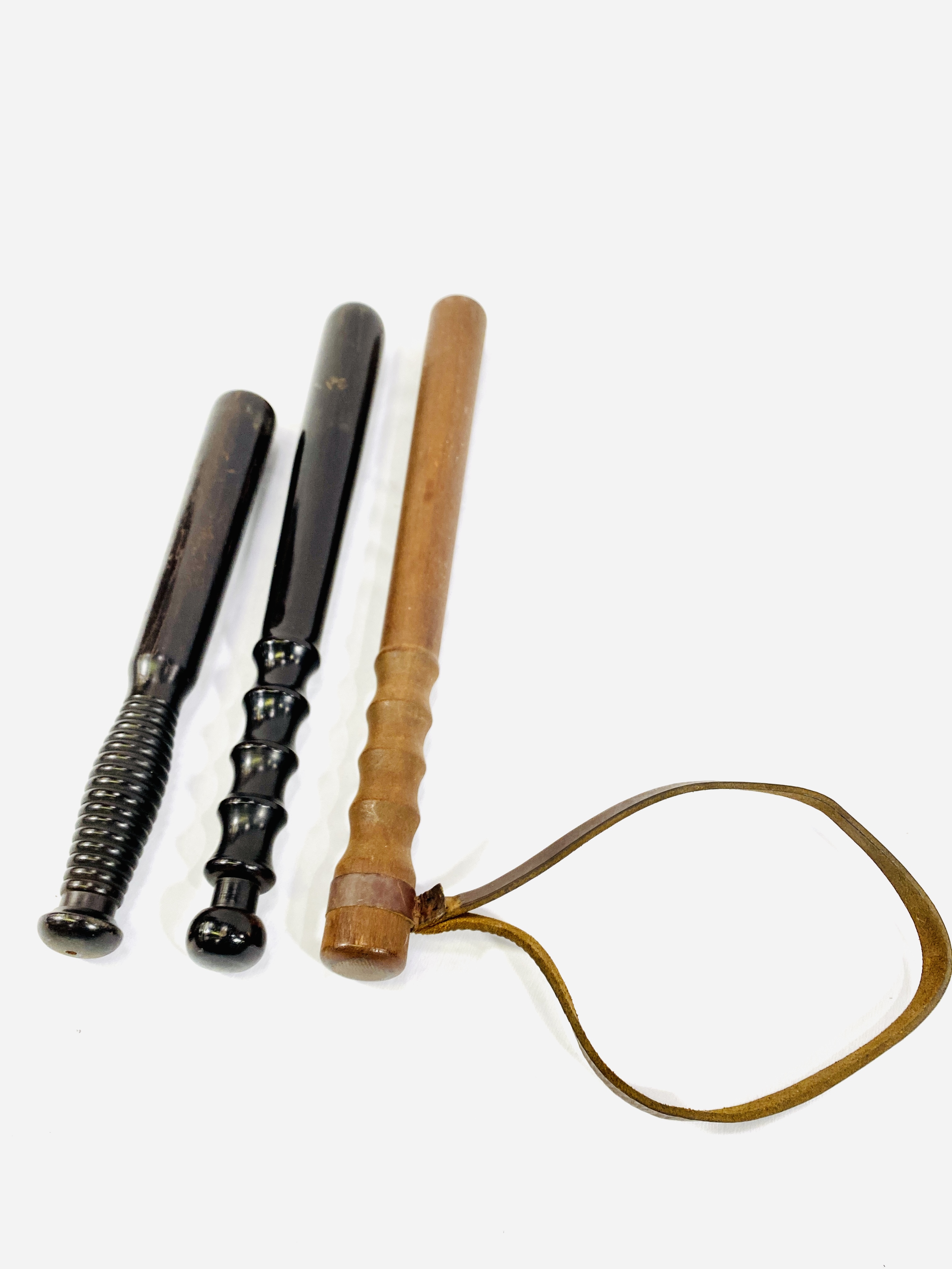 Two ebony truncheons along with one other