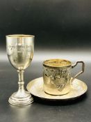 Continental 800 silver repousse decorated cup and saucer, and a silver goblet