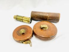 Two brass telescopes and two leather covered tape measures