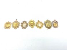 Collection of seven mainly 1920's 9ct gold shooting medal fobs