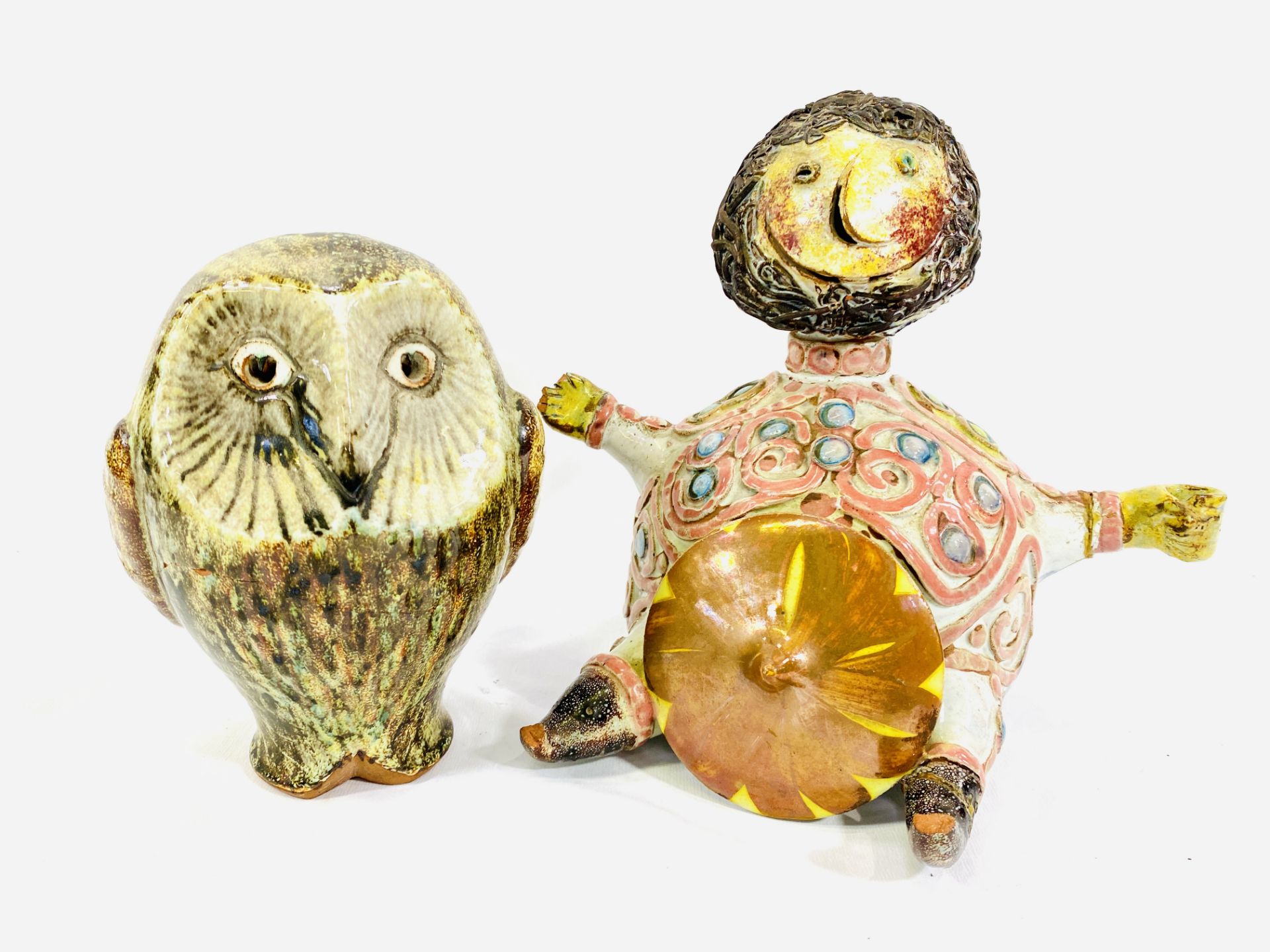 A studio pottery owl and figure of a seated man