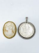 Silver thaler in pendant frame together with a brooch