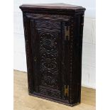 Corner cupboard with carved door