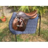 17” brown Ideal saddle, medium fit, with stirrups and leathers.