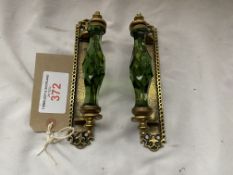 A pair of green glass and brass door handles