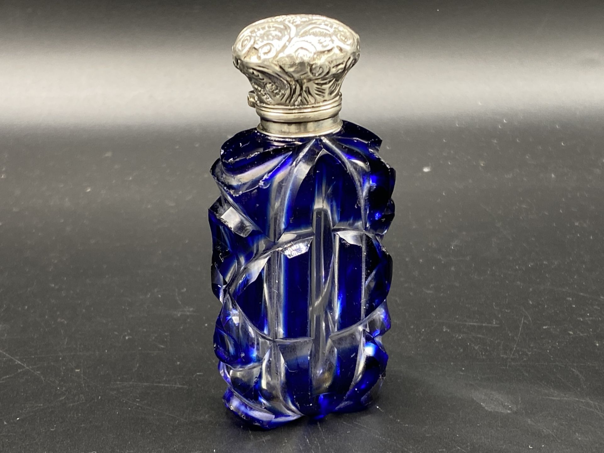 Glass scent bottle with silver top