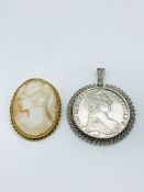 Silver thaler in pendant frame together with a brooch