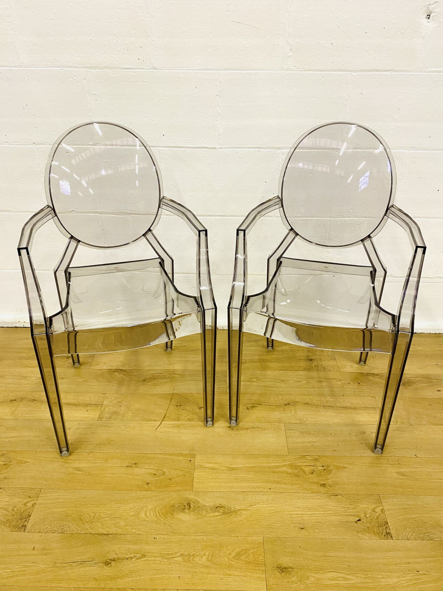 Two Kartell clear plastic armchairs