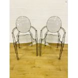 Two Kartell clear plastic armchairs