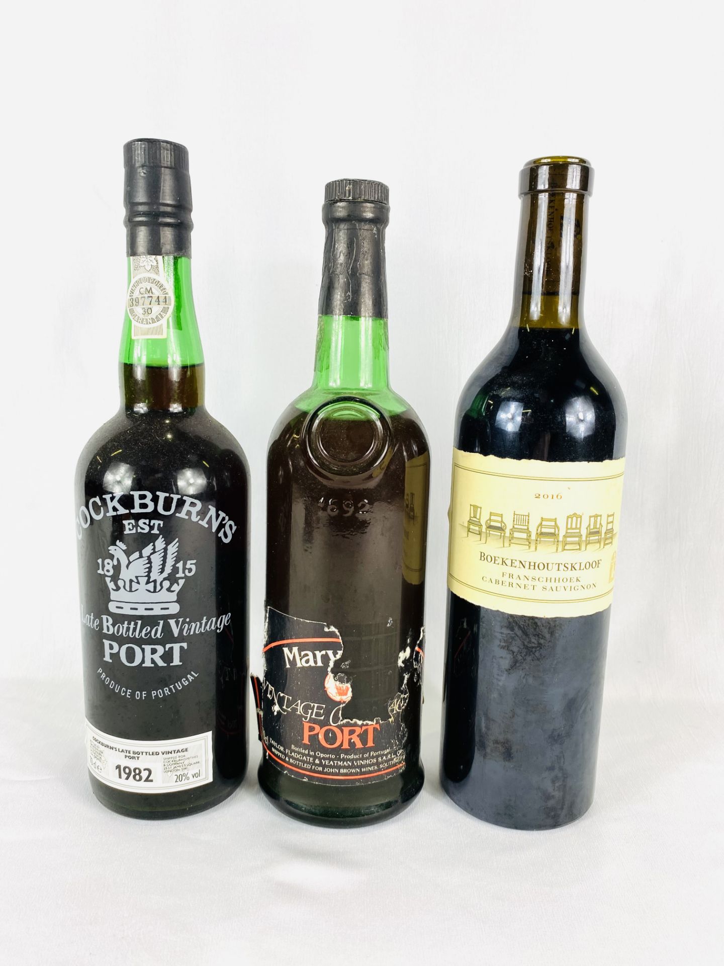 Two bottles of port together with a bottle of wine