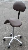 1 x Beauty Salon Height-Adjustable Treatment Saddle Stool In A Faux Brown Leather - Removed From A