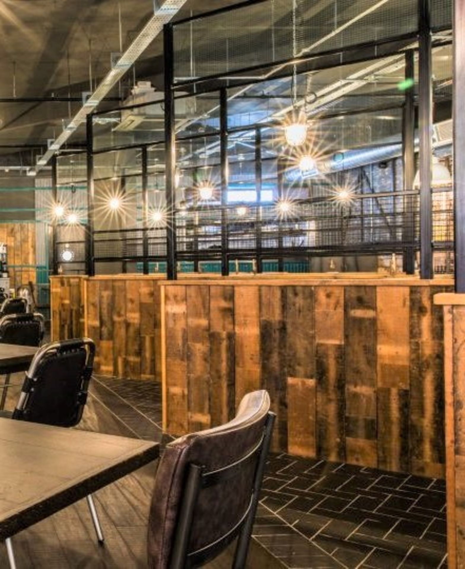 Large Seating Booth Area Featuring Rustic Wood Dividers Under Industrial Style Height Extenders - Image 2 of 27