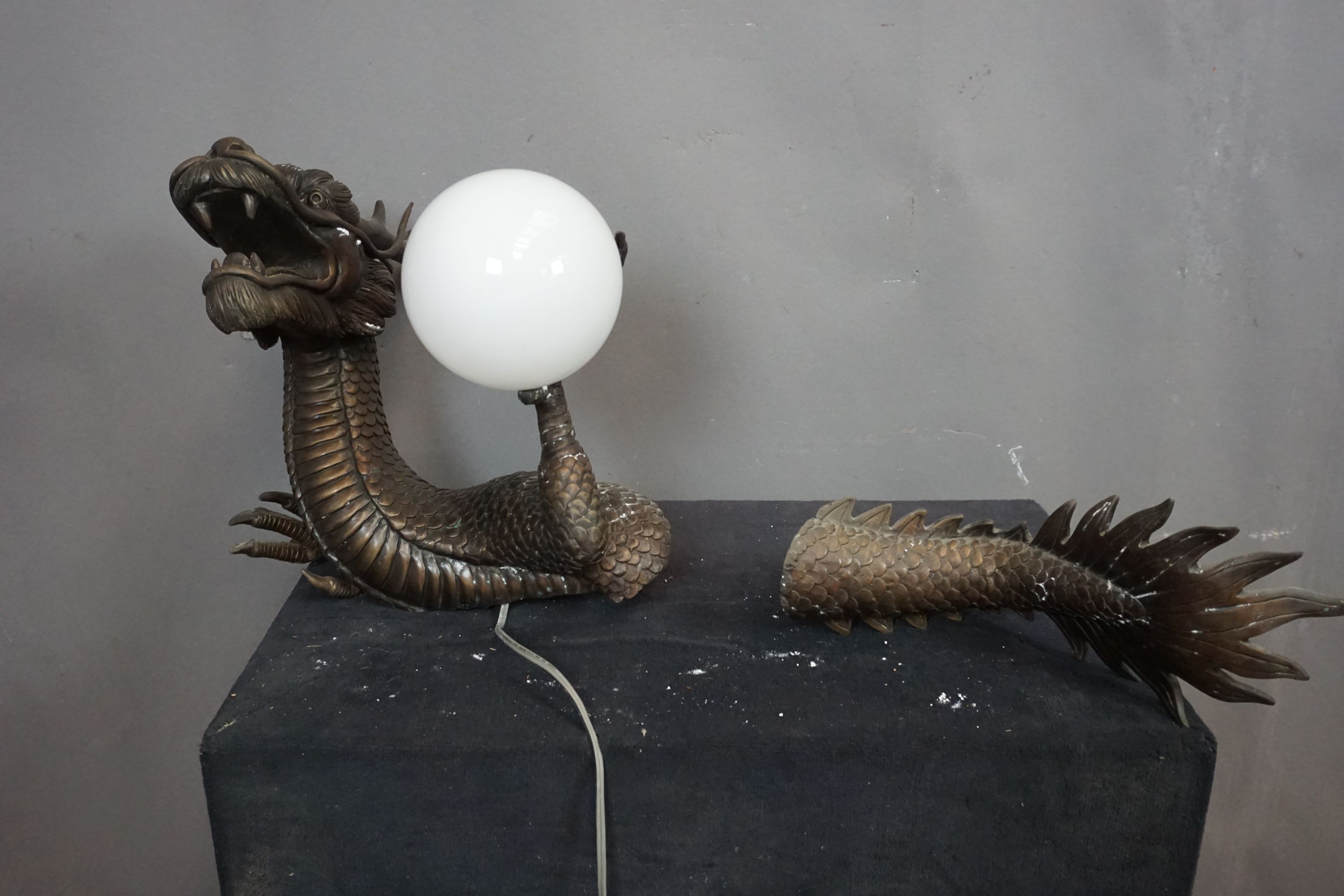 Wall lamp in bronze, dragon coming in and out of the wall