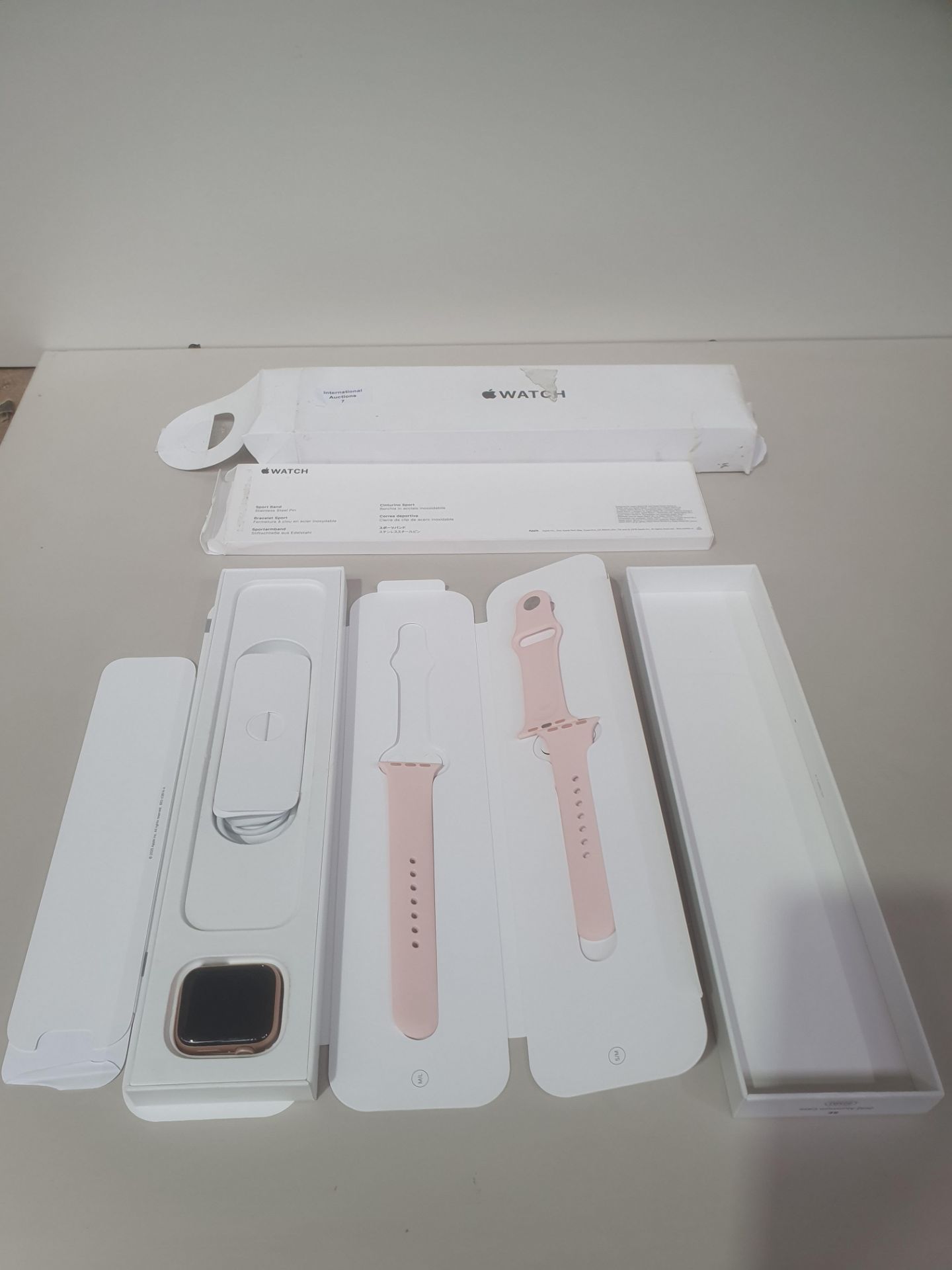 APPLE WATCH WITH PINK STRAP - SCREEN HAS COSMETIC DAMAGE AT THE CORNER