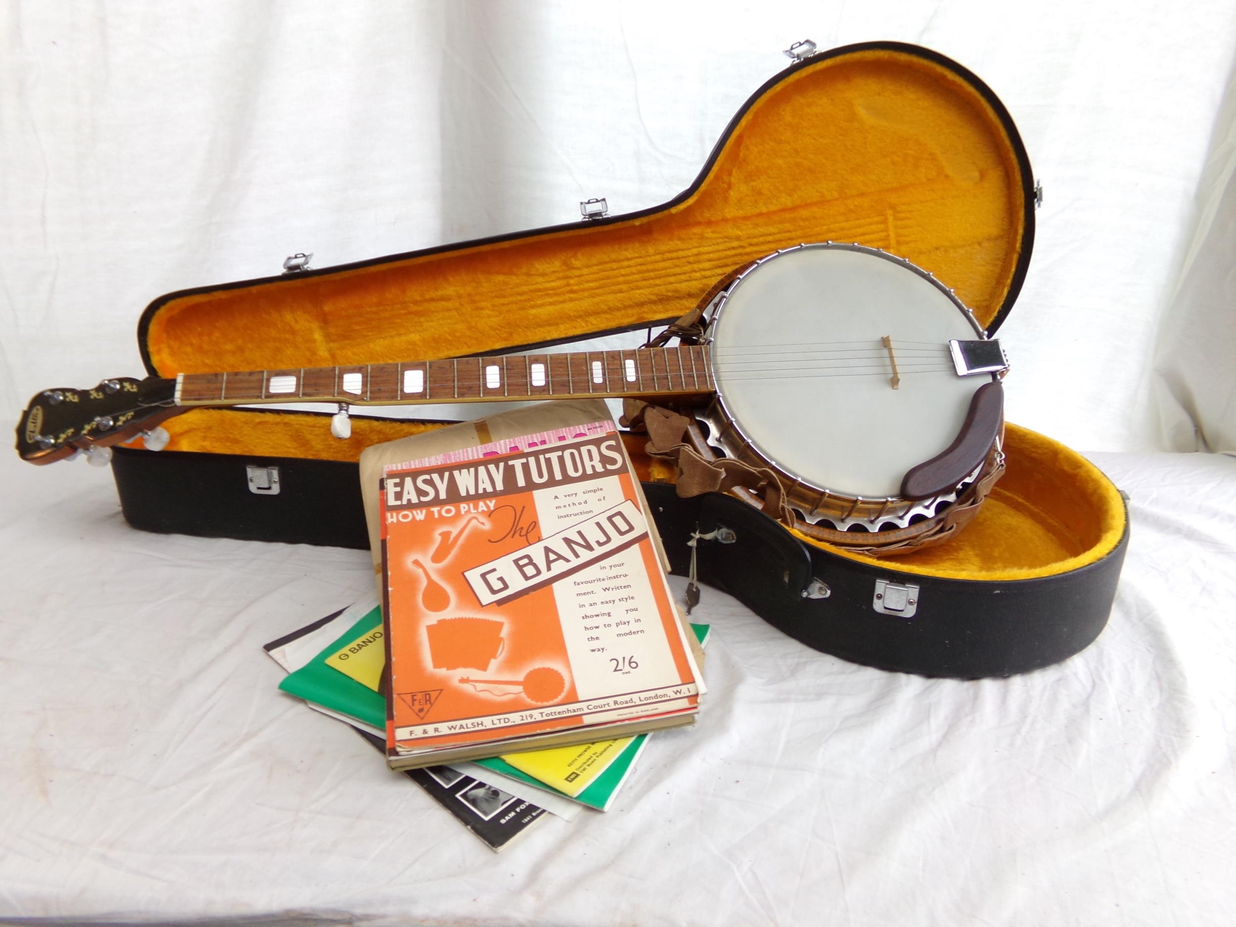 Shelton banjo in hard case, with a quantity of sheet music