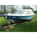 Shetland cabin cruiser in need of restoration, upon a single axle trailer