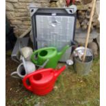 Galvanised drain stand and two drain covers by Clark Drain, with two galvanised watering cans,