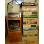 Collection of vintage Aiwa stacking audio equipment, mostly in original boxes, with a glazed