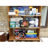 Three shelves of electronics and gadgets to include Nintendo Wii, Formula Force GP racing wheel,