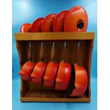 Le Creuset - Graduated set of five lidded saucepans in burnt orange on a pine display stand (largest