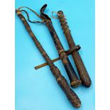 Antique lacquered police truncheon, with a further truncheon type baton and another ethnic