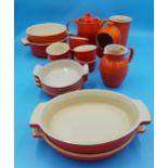 Le Creuset - Collection of kitchenware to include various twin handled dishes, tea pot, salt pig,