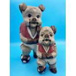 Pair of novelty hand carved pigs dressed as footballers, 40 and 29 cm high respectively