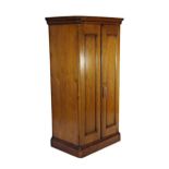 19th century fruitwood cupboard of small proportions, the twin panel doors enclosing a shelved