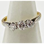 An 18ct three stone platinum set diamond ring central .25ct flanked by two .15ct stones, Size O, 3.
