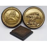 Pair of antique polished bronze circular wall plaques, both cast in relief, one with an eagle the